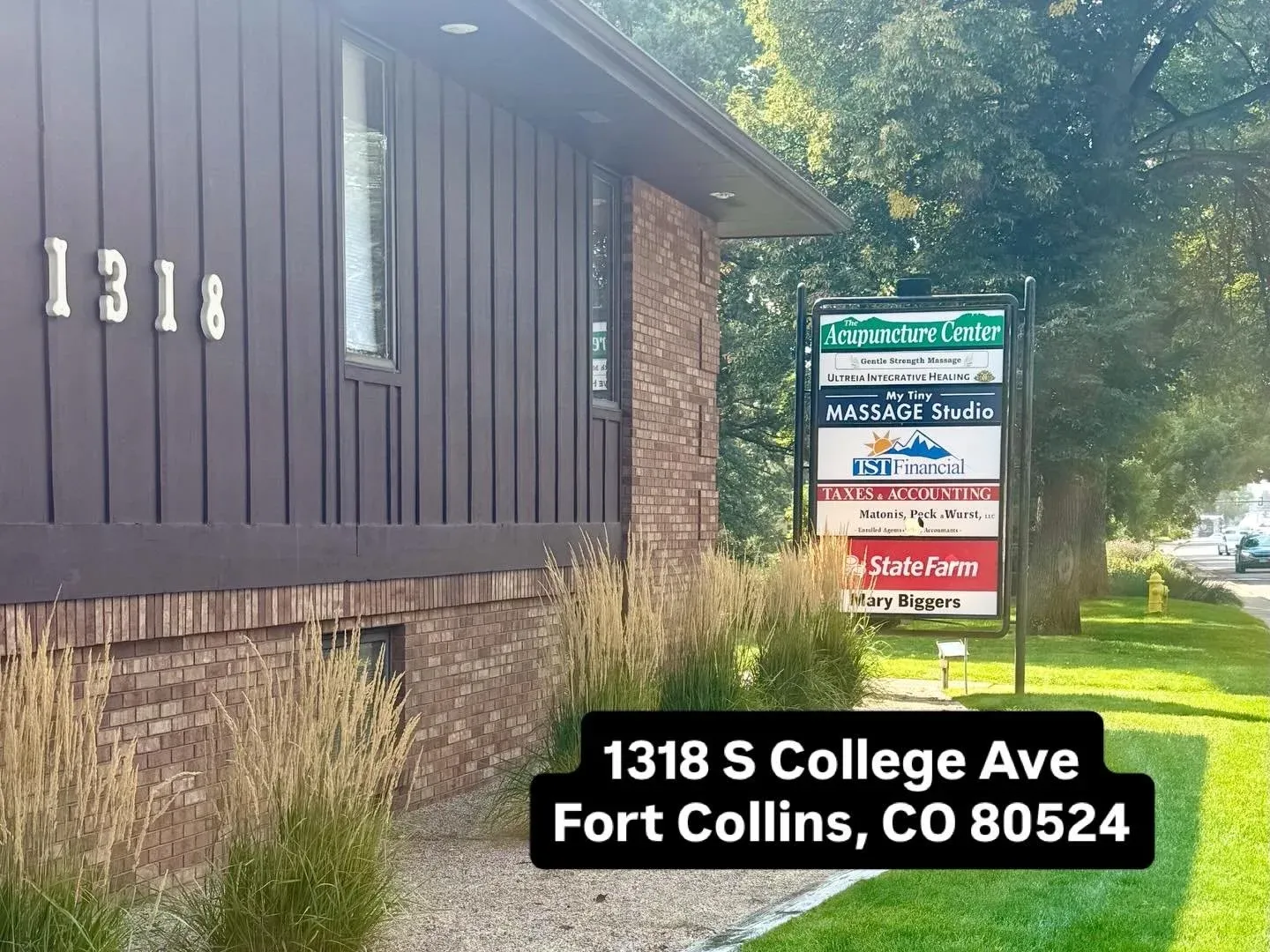Close-up of the studio entrance at 1318 S. College Ave with the tenant signage column visible