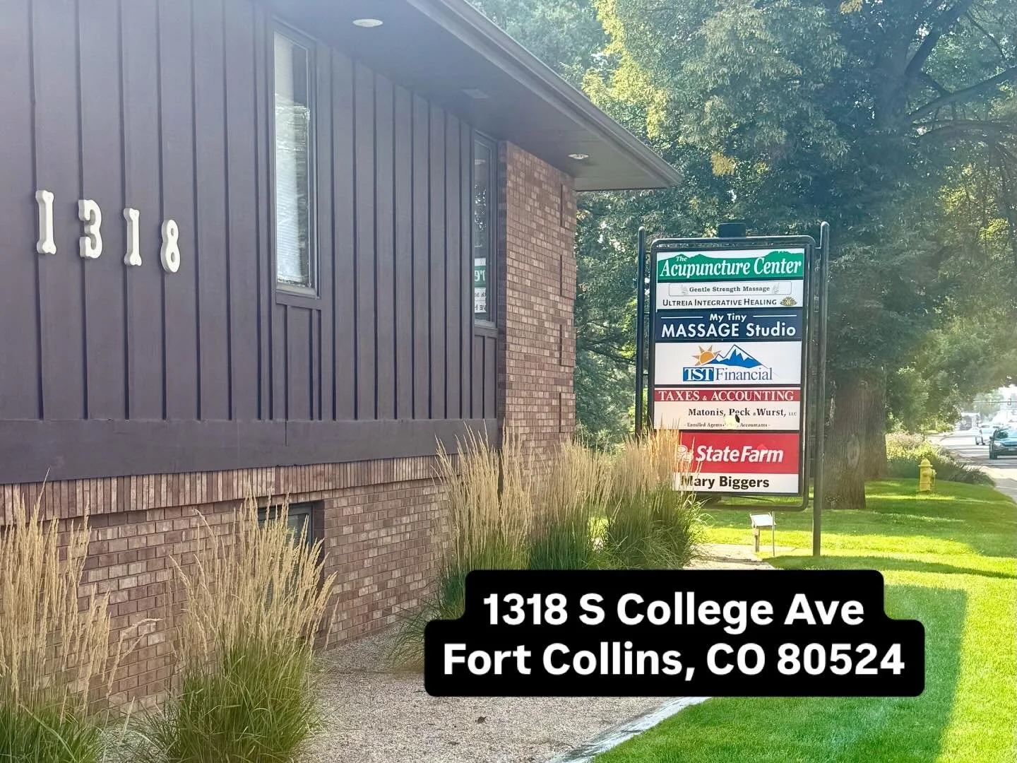 Studio entrance at 1318 S. College Ave with tenant signage and building address visible